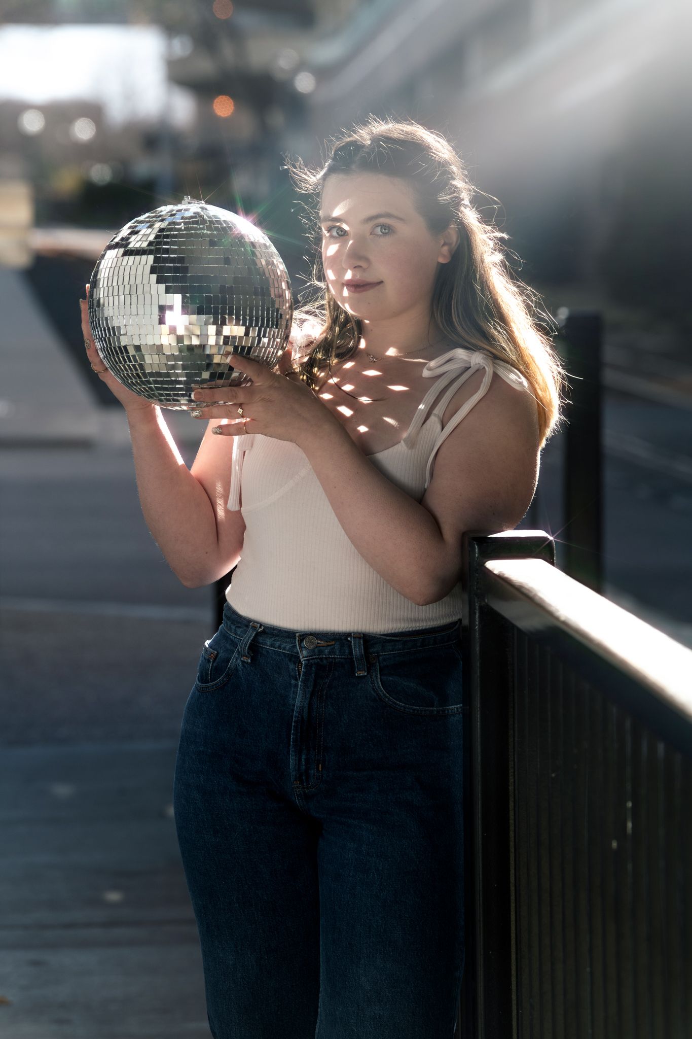 high school senior girl holding disco ball