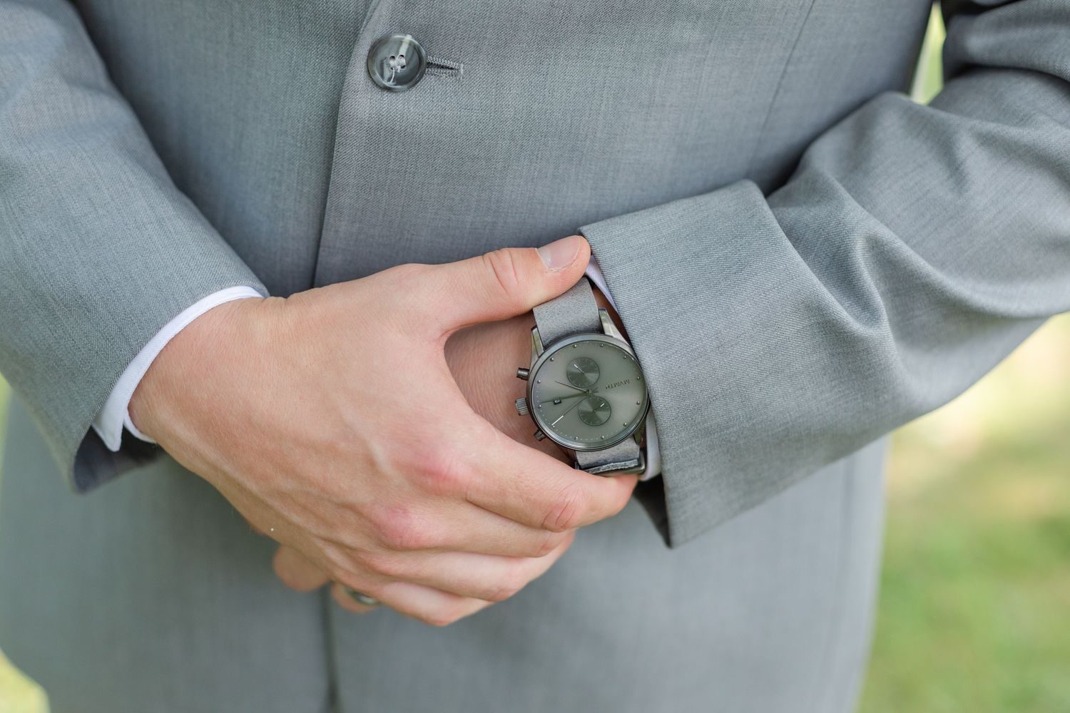 Detail shots of gray suit jacket buttons and fabric textures.