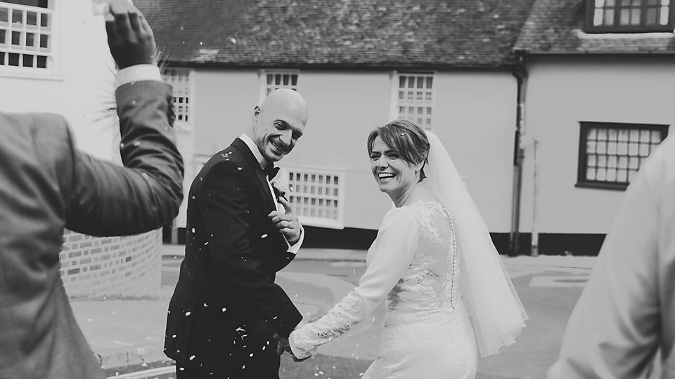 Black and white wedding celebration photos showing joyful moments outdoors.