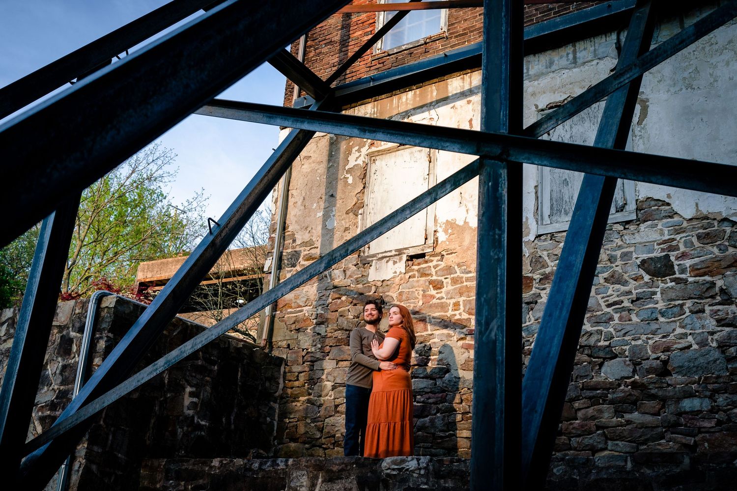 Industrial architecture with steel beams and stone walls under natural lighting.