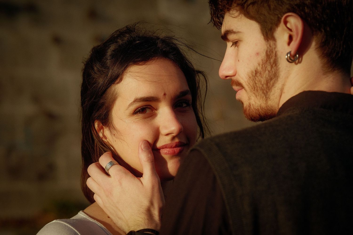 An intimate moment shared between two people in warm lighting.