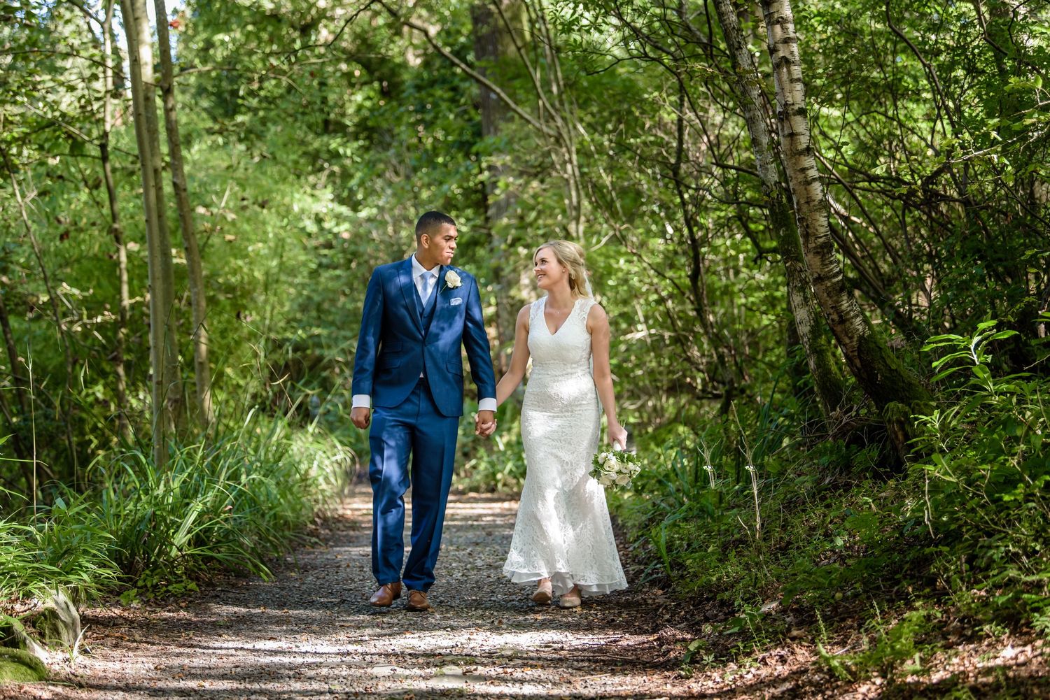 Bride and groom walking in woods at Cragwood Country House
