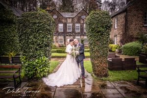 Bride and groom smiling with bouquet at Whitley Hall