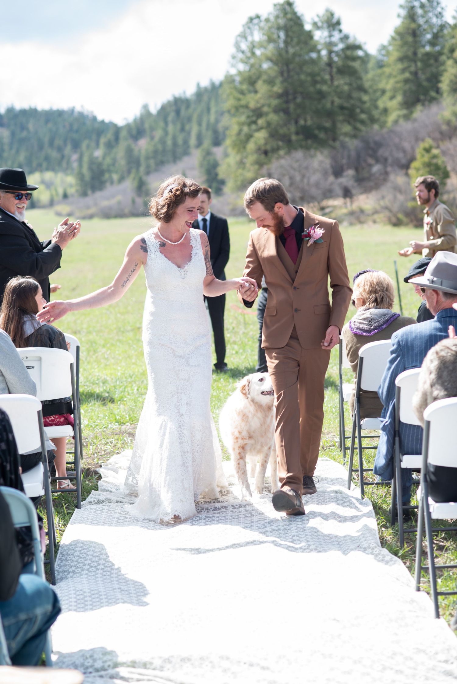 Bride and Groom walking down the aisle with their dog
