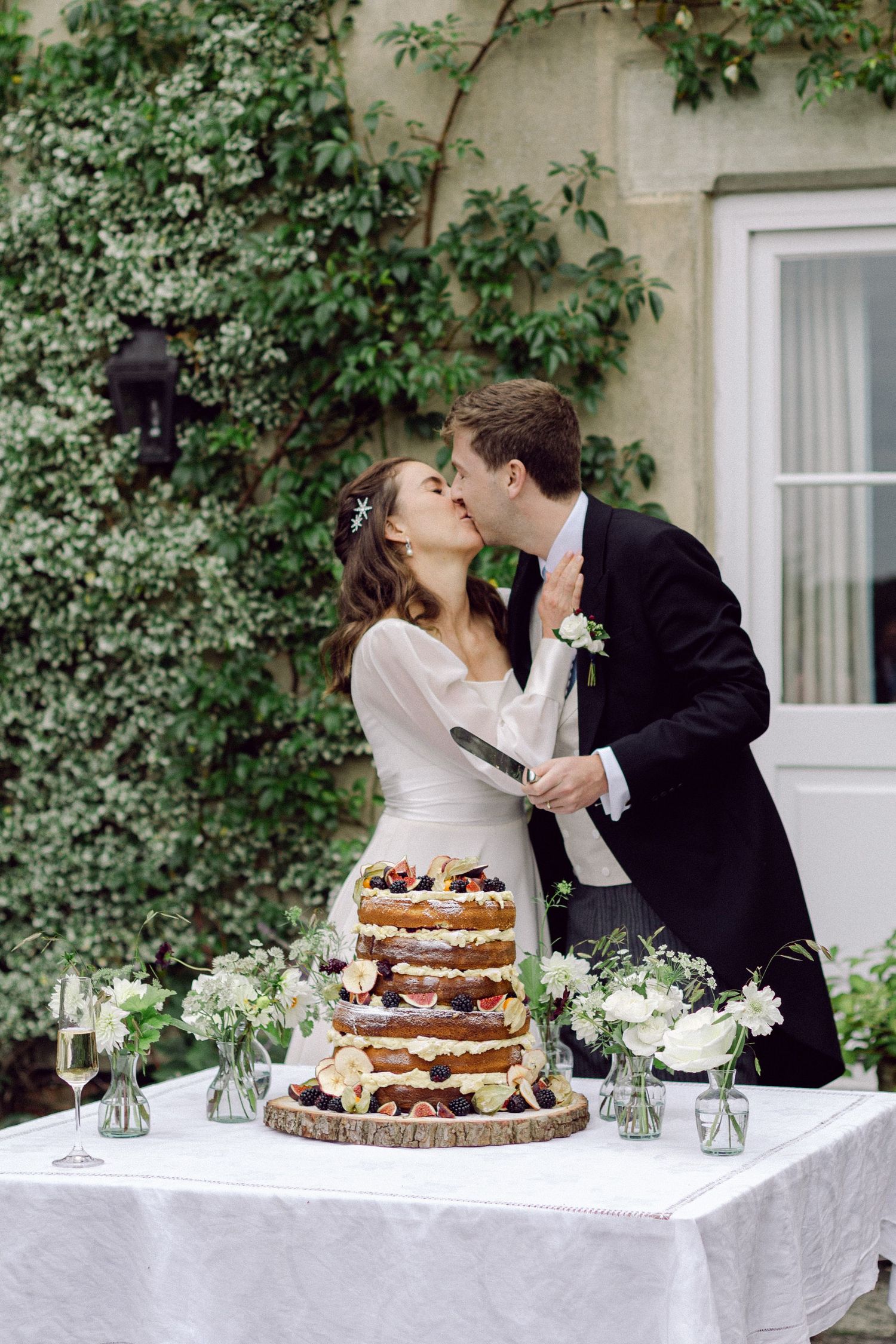 Outside cake cutting at English countryside wedding