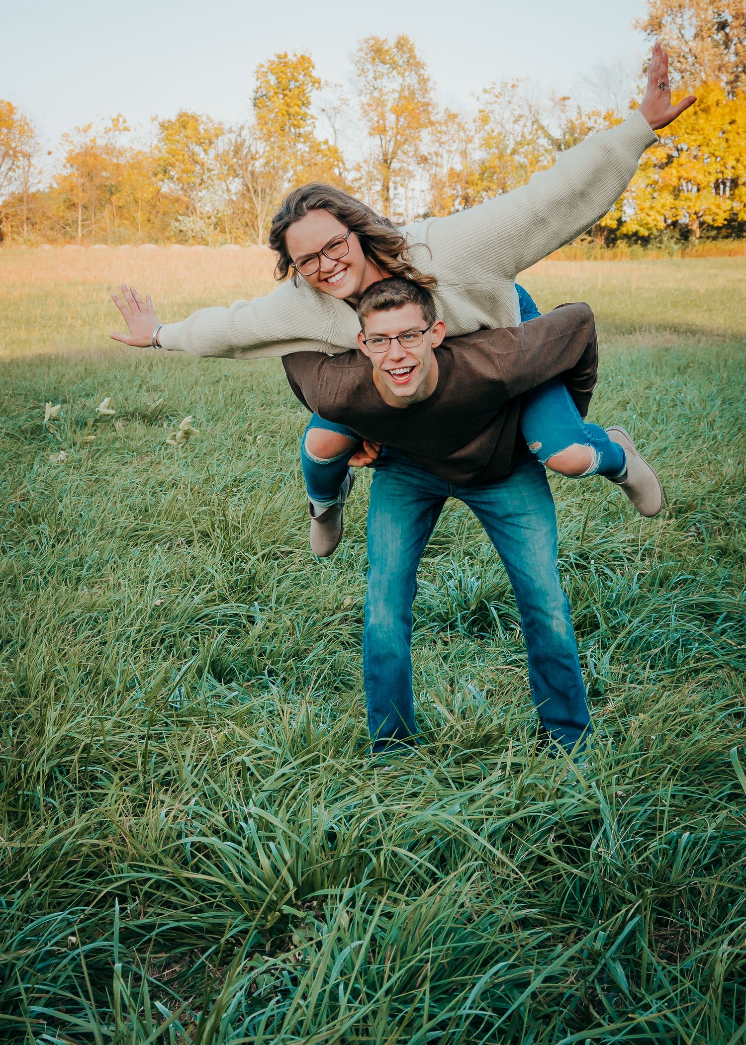 couple pose with a piggyback ride during photo session