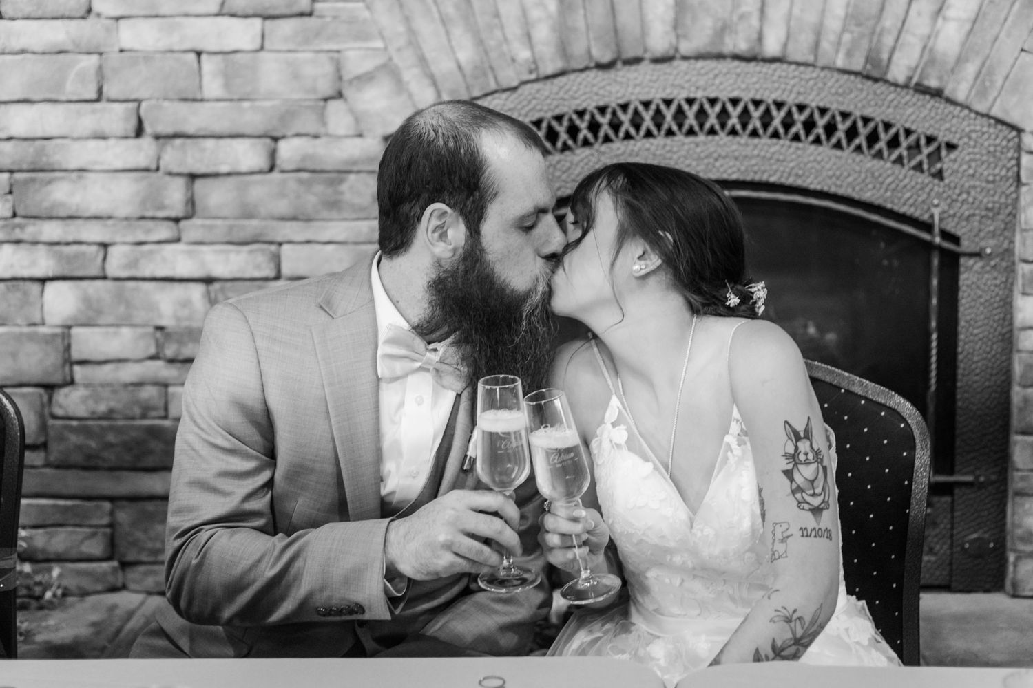 A couple toasts with champagne glasses while sharing an intimate moment.