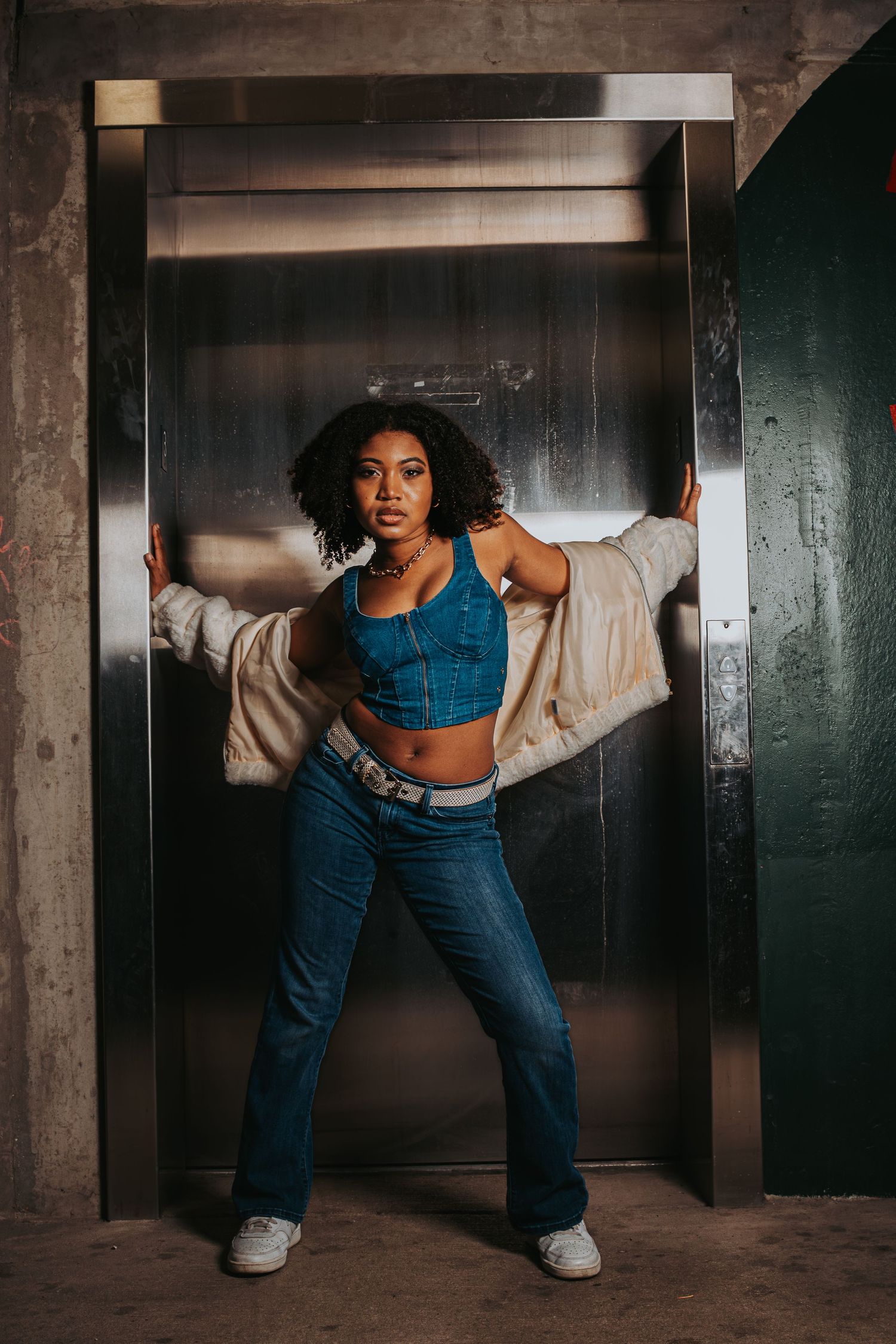 Dynamic dance poses captured in a gritty industrial hallway setting with dramatic lighting.