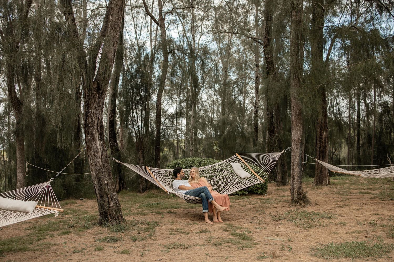 couple sitting in hammock on Maui beach