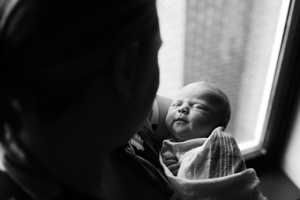 Black and white image of new mother looking at  her newborn.  Location was Piedmont Hospital in Augusta, GA.