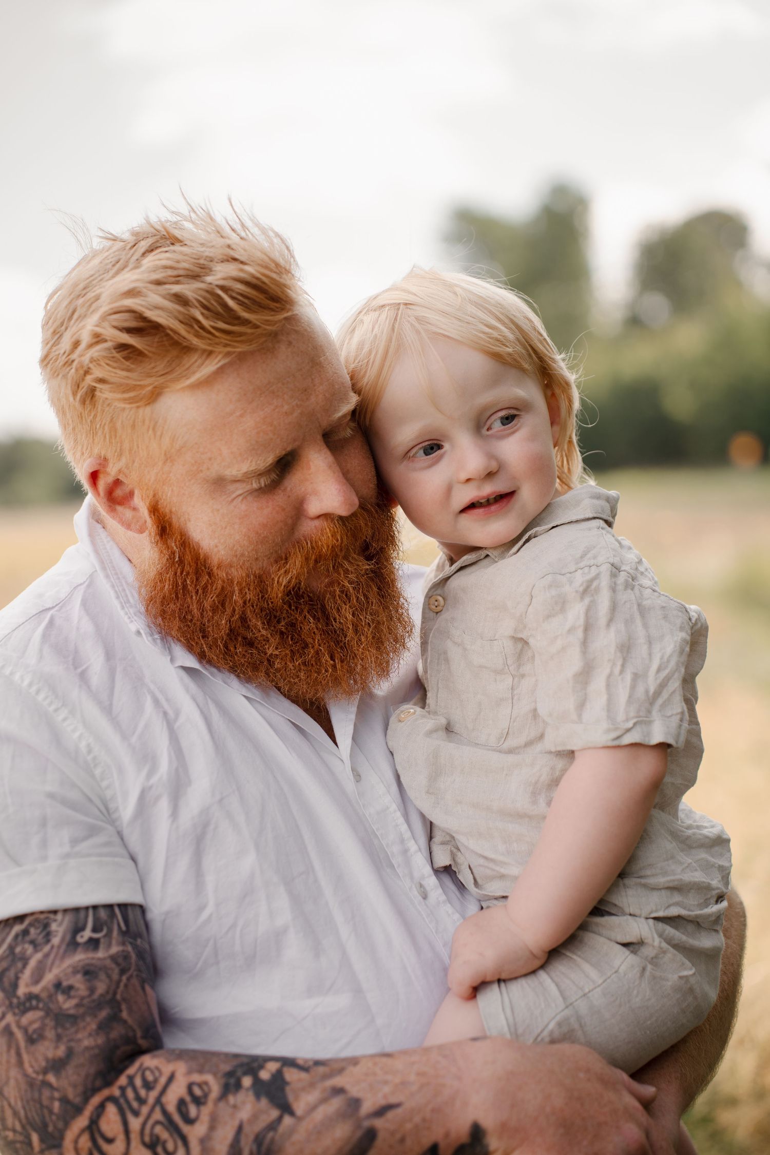 Tender outdoor portrait in golden light with natural countryside background.