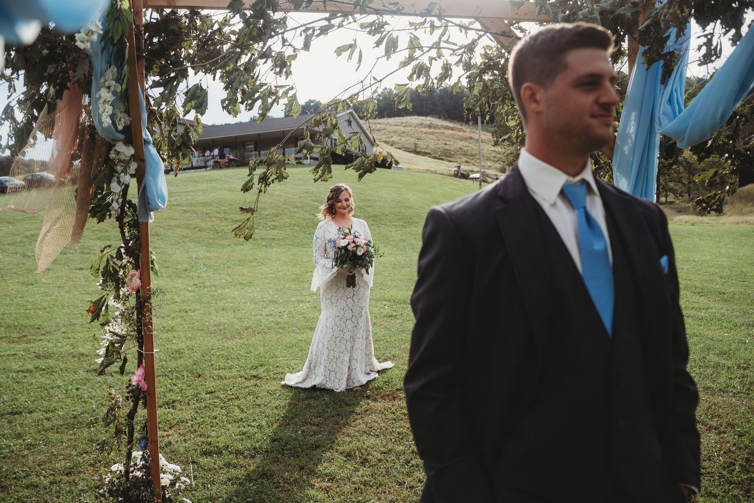 Wedding ceremony setup in an outdoor garden with blue accents.