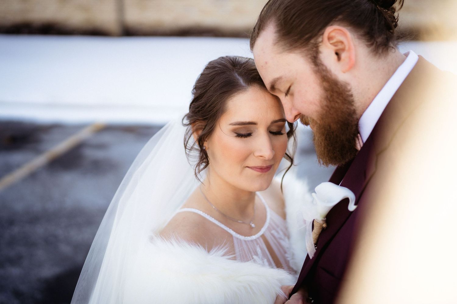 Intimate wedding portrait capturing a tender moment between newlyweds.