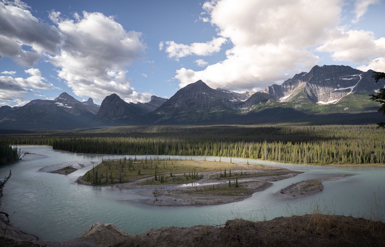 A panoramic view of the mountains and river in Jasper National Park, Alberta, Canada.