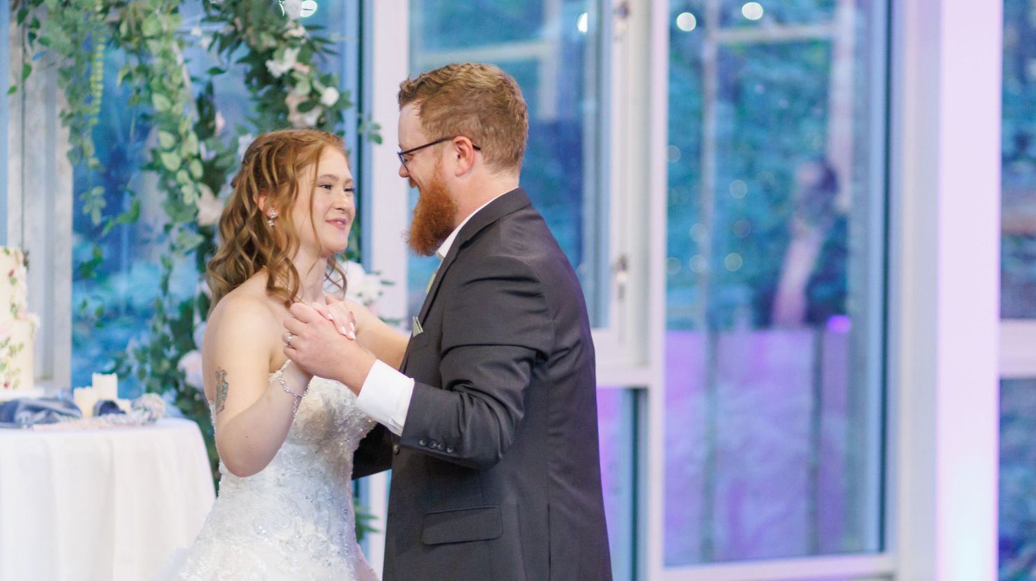 A captivating shot of Elizabeth and Christopher sharing a romantic moment under the canopy of trees at Dunwoody Nature Center, bathed in nat