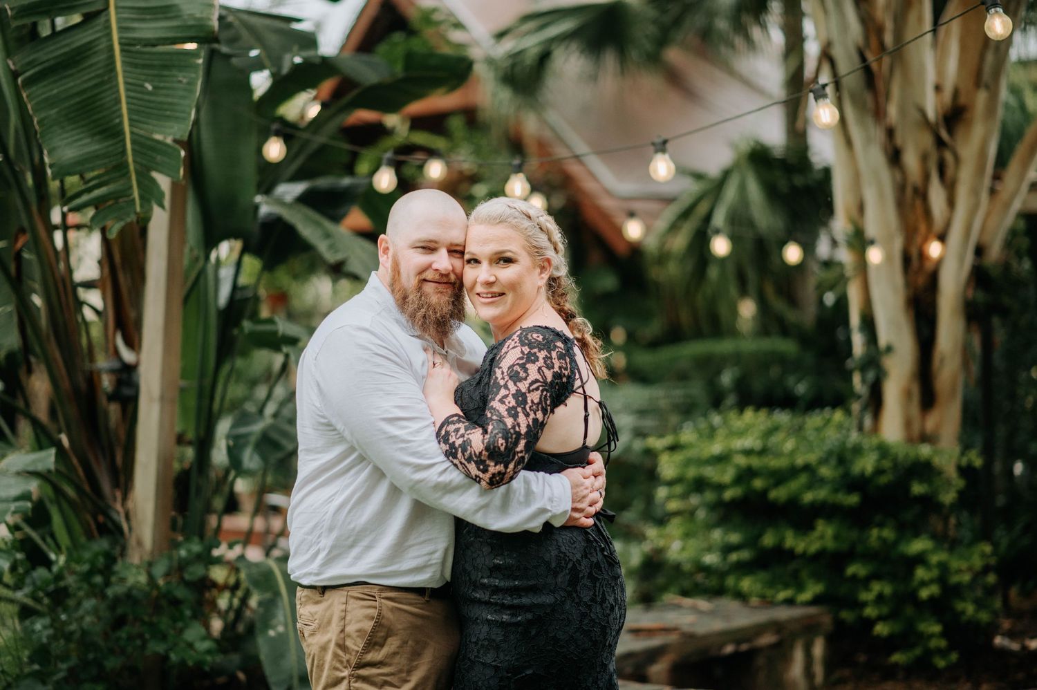 Intimate portrait in a lush tropical garden with palm trees.