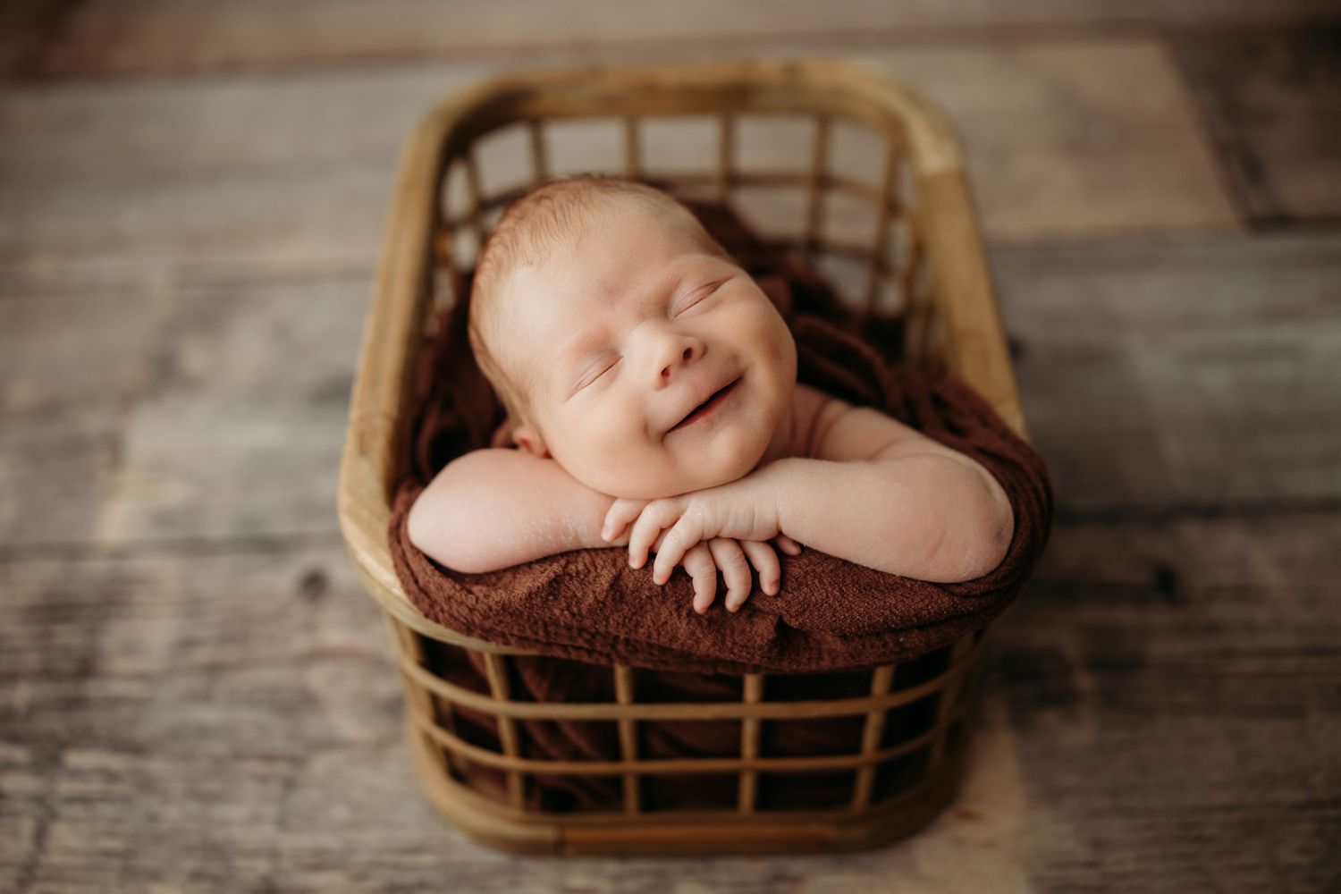 Rustic wooden basket on aged wooden floor with soft lighting.