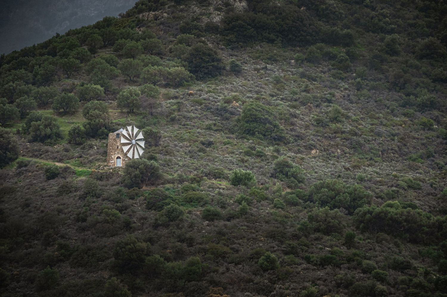 A scenic mountain landscape with rugged terrain and vegetation stretches across multiple connected panoramic views.