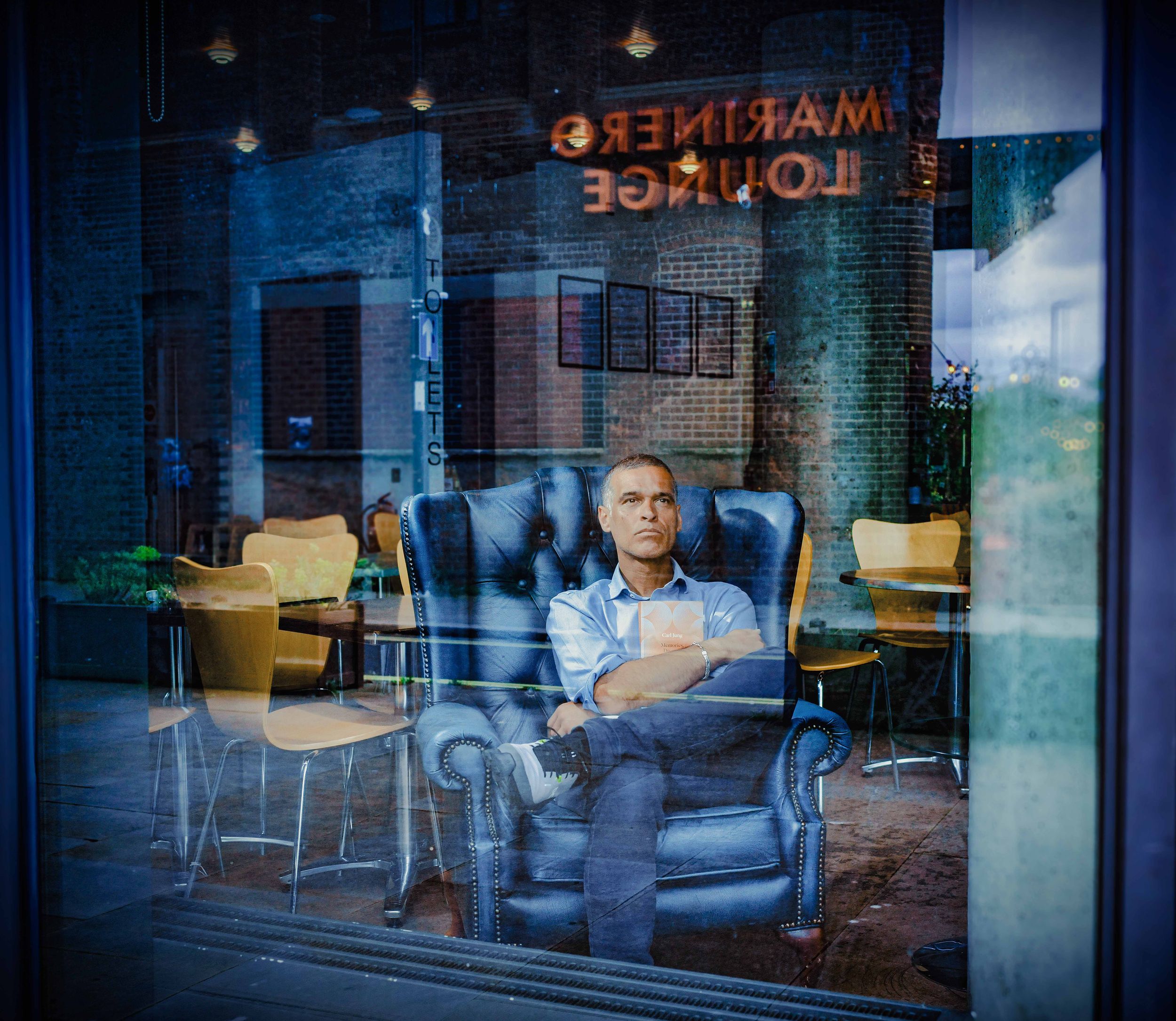 My Favourite Book Photo project: Portrait of Dance East CEO Anthony Missen, holding his favourite book for 2026 exhibition. By John Ferguson