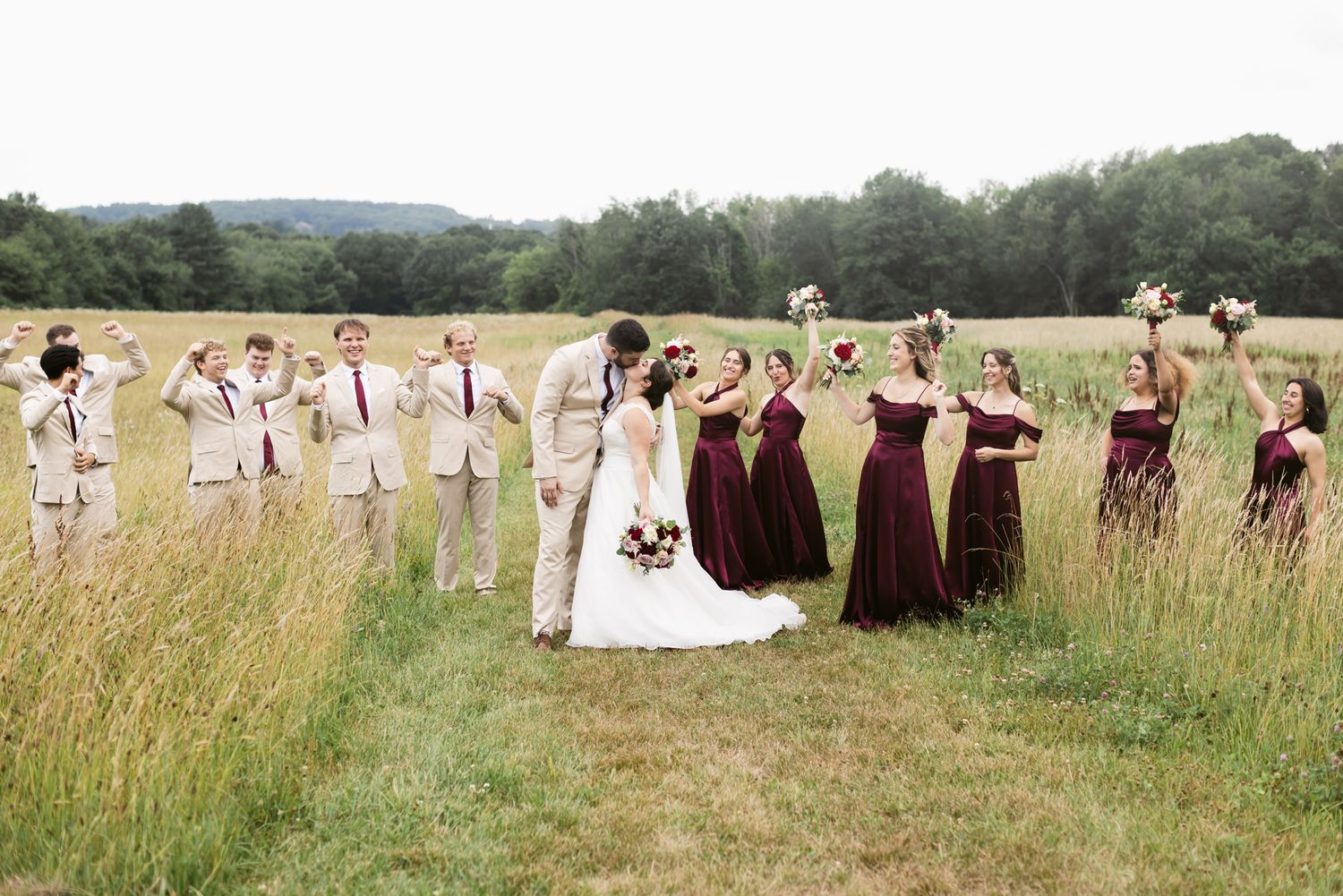 Wedding party photos in a lush green field on a cloudy day in Bradford, Essex County Massachusetts. Lakes Region NH wedding photographer.