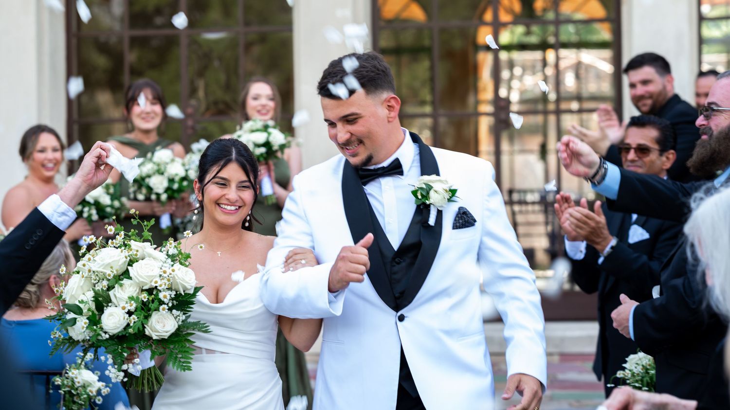 Palm Beach Wedding Photographers captured this bride and groom walking down the aisle to celebrating guest moments after their union.