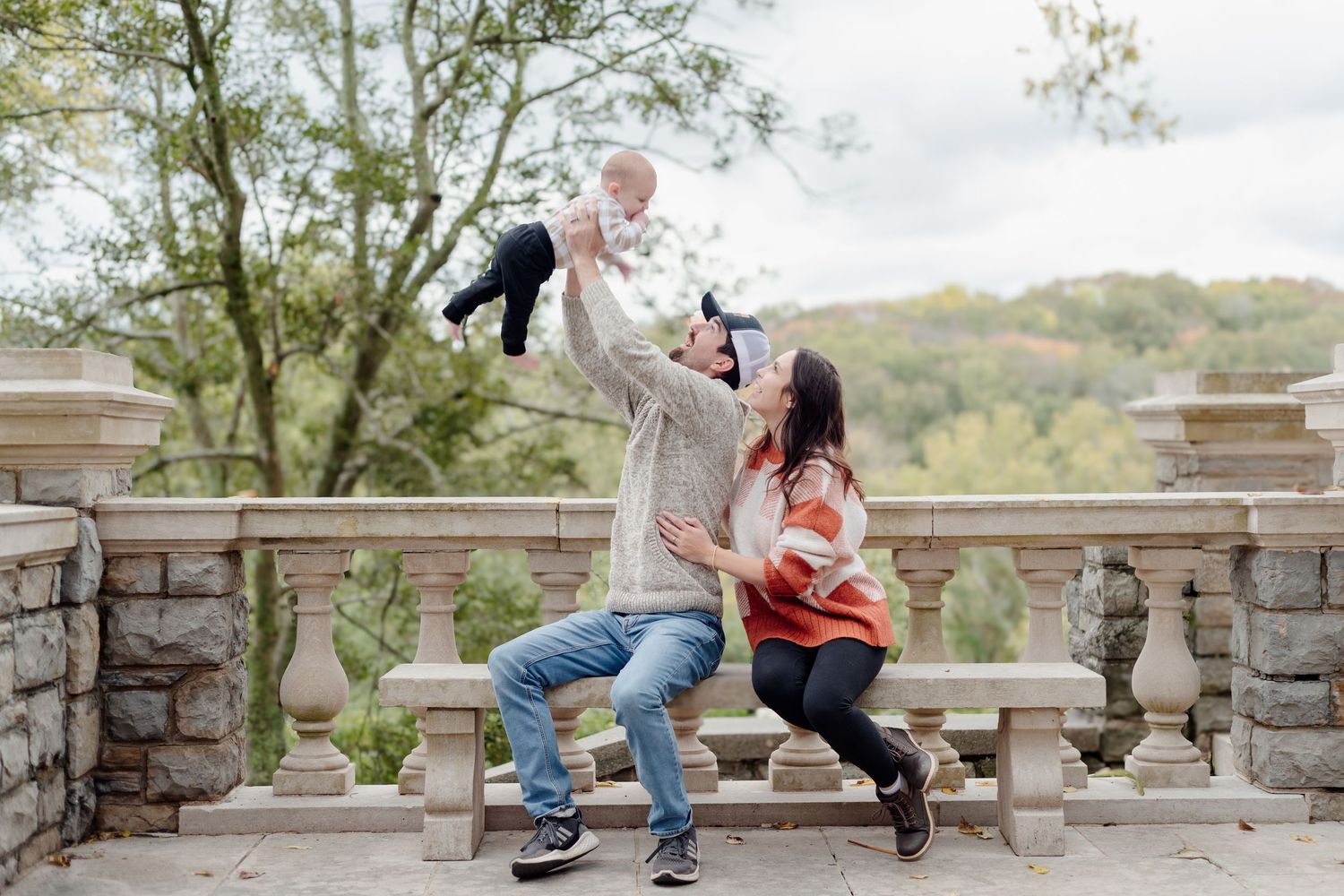 Parents tossing baby during outdoor family session in Central Texas