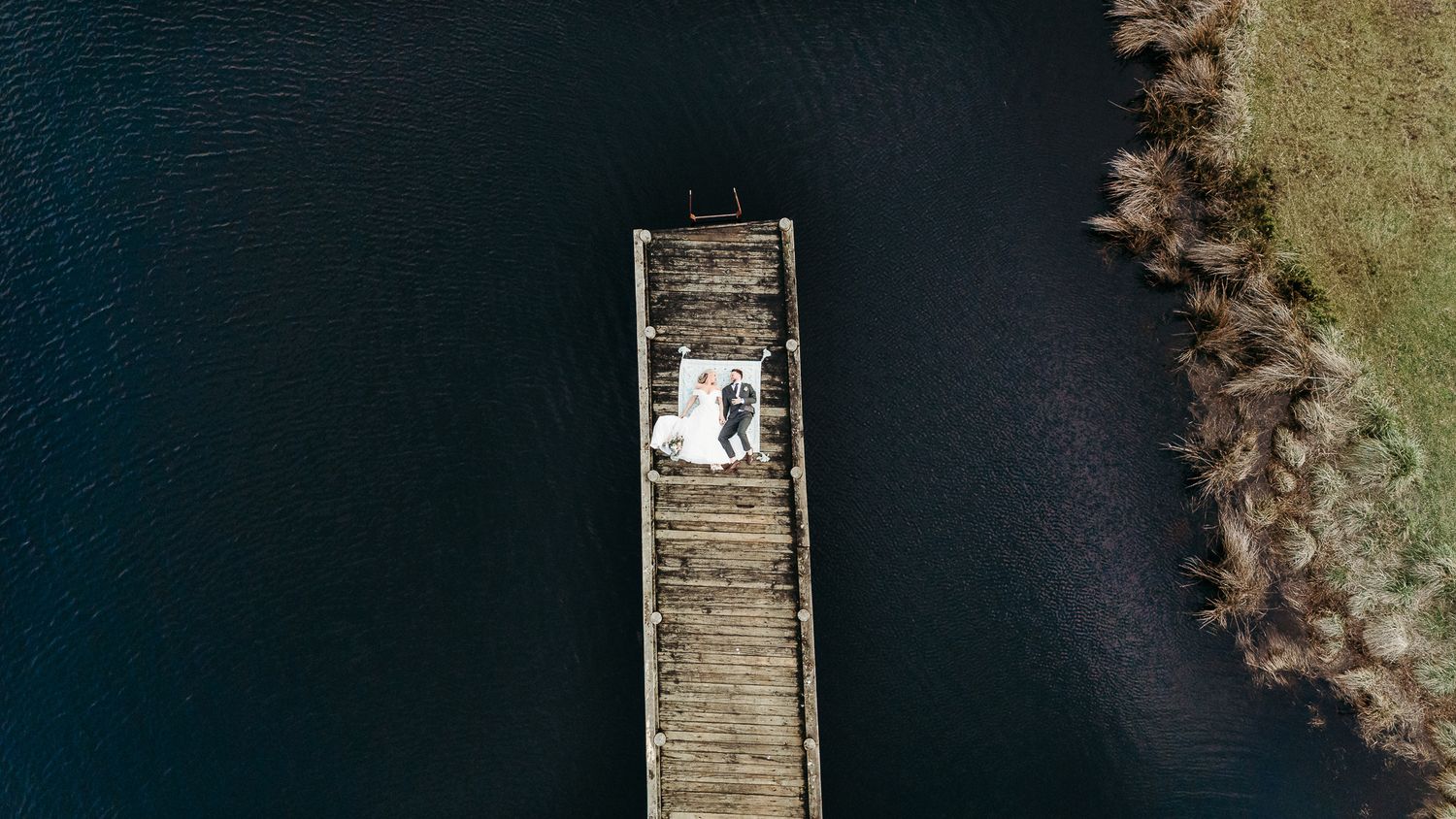 elopement photo on a jetty taken in Franklin, Tasmania by Joss Jensen Photography. Drone photo