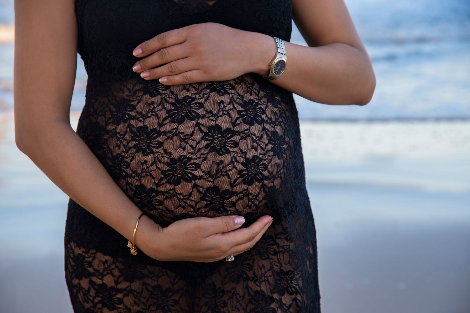 Maternity photographer Gold Coast featuring luxury designer gown at sunset.