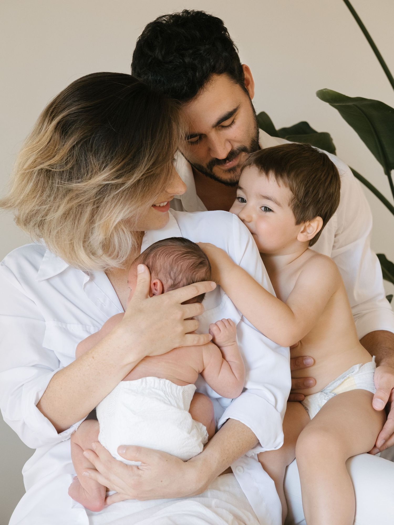 Intimate black and white portrait of parents with sleeping newborn.