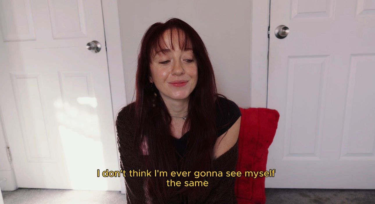 A screenshot from a video showing text overlay that reads "I don't think I'm ever gonna see myself the same".