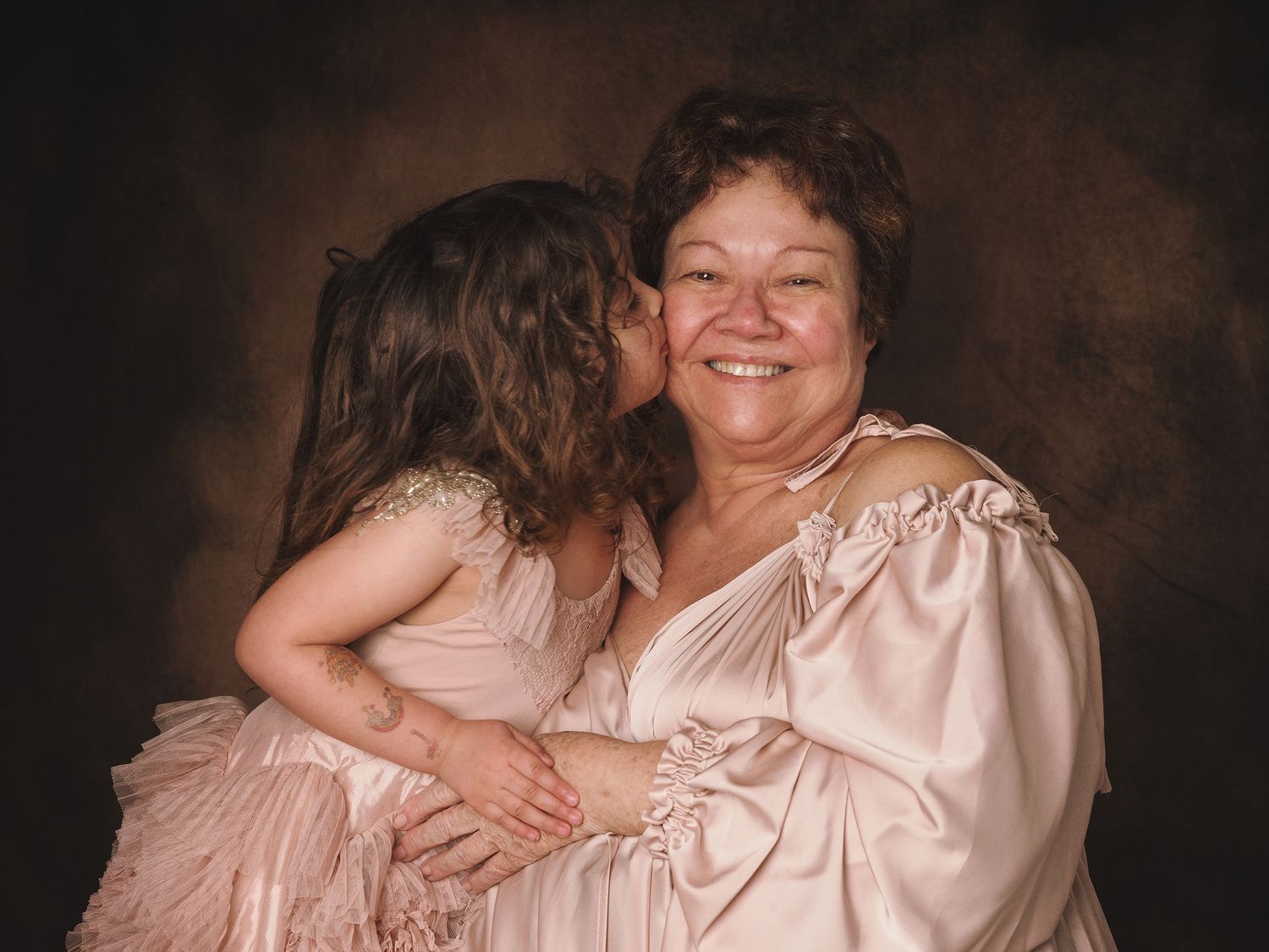Two people embracing and laughing together in a warm and intimate candid photo session.