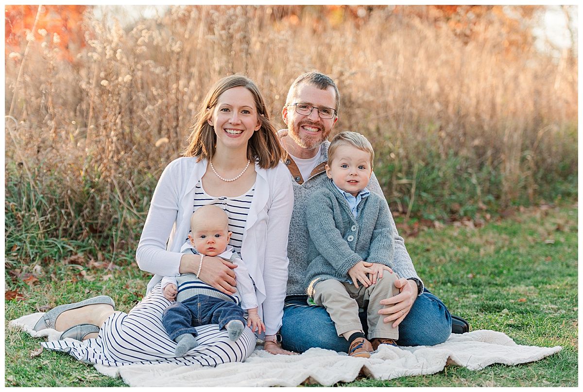 Young Family Seated Portrait Pose for Fall Photography Session in Starkey Park Zionsville Indiana