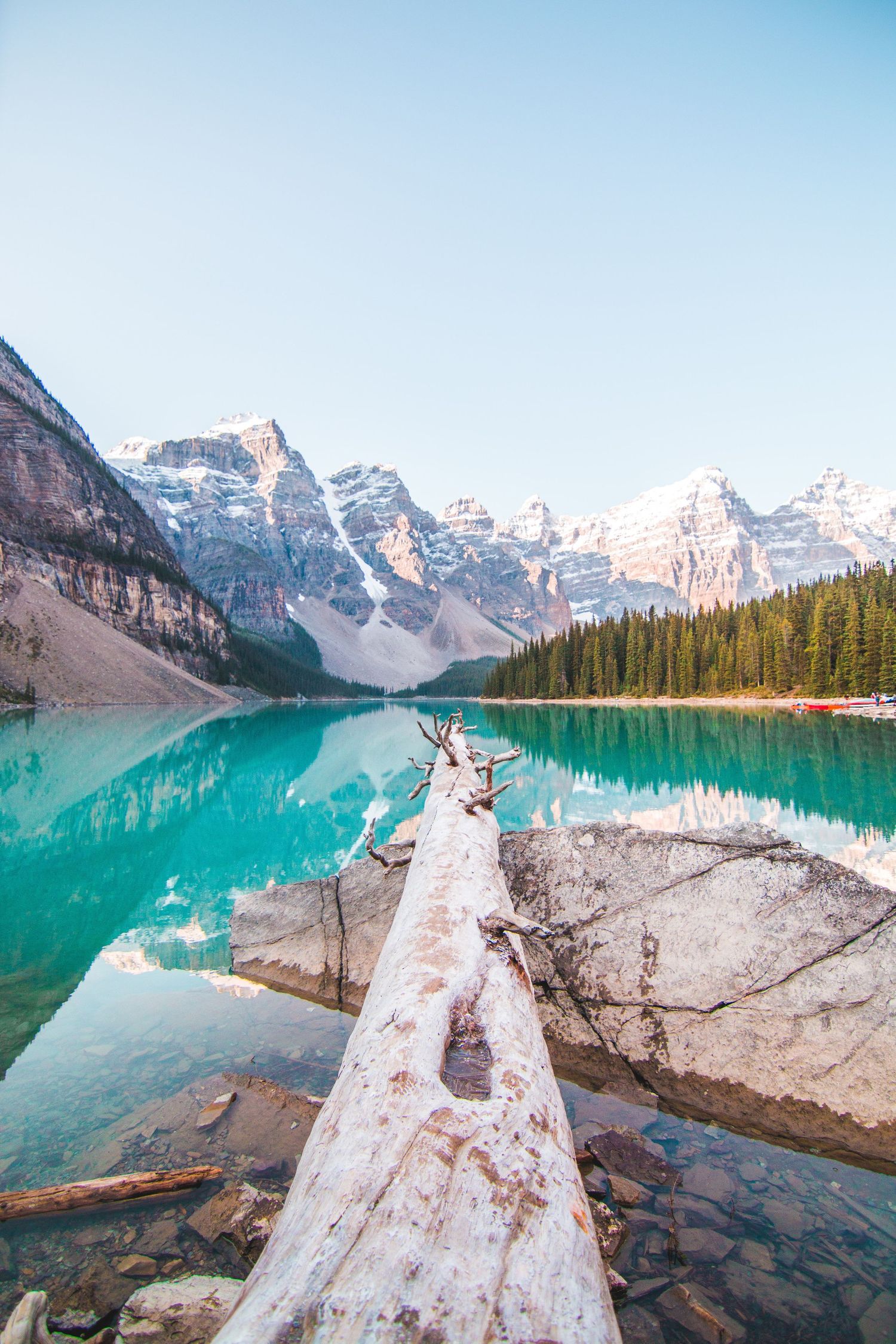 Stunning turquoise waters reflect snowy mountain range of Banff, Canada