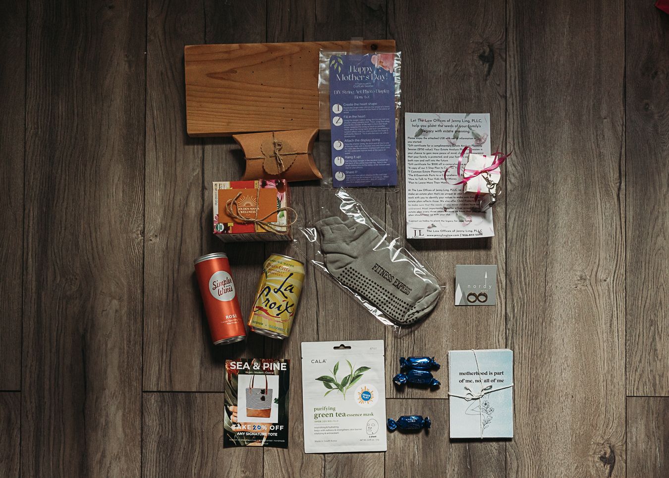 Flatlay of books and planning materials arranged on wooden floor.