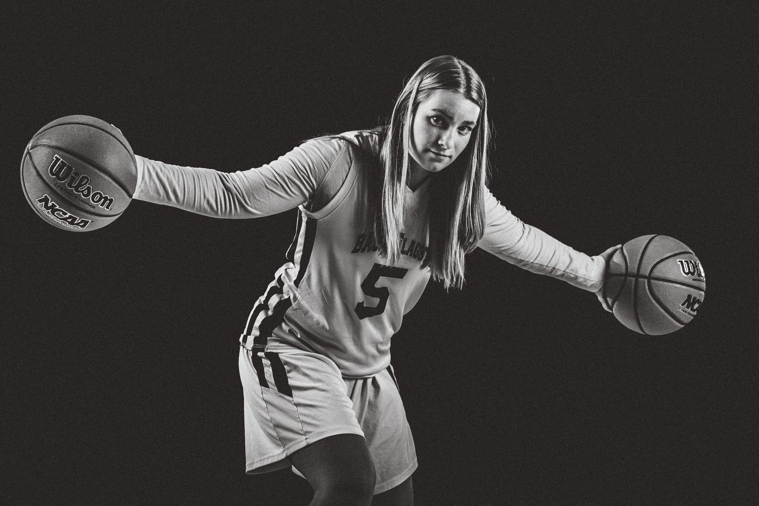 Kelsey Newton, palming two basketballs, poses for Flagstaff photographer, Sean Openshaw.