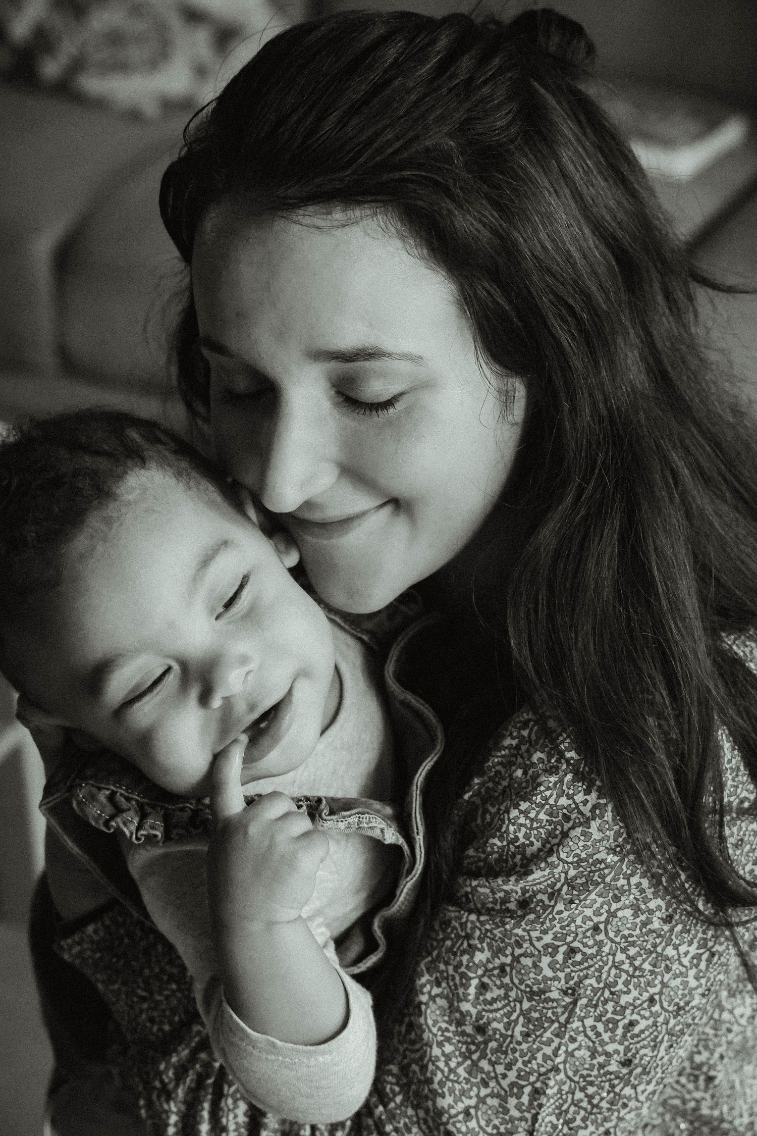 A sweet black and white portrait showing an intimate moment of connection and joy.