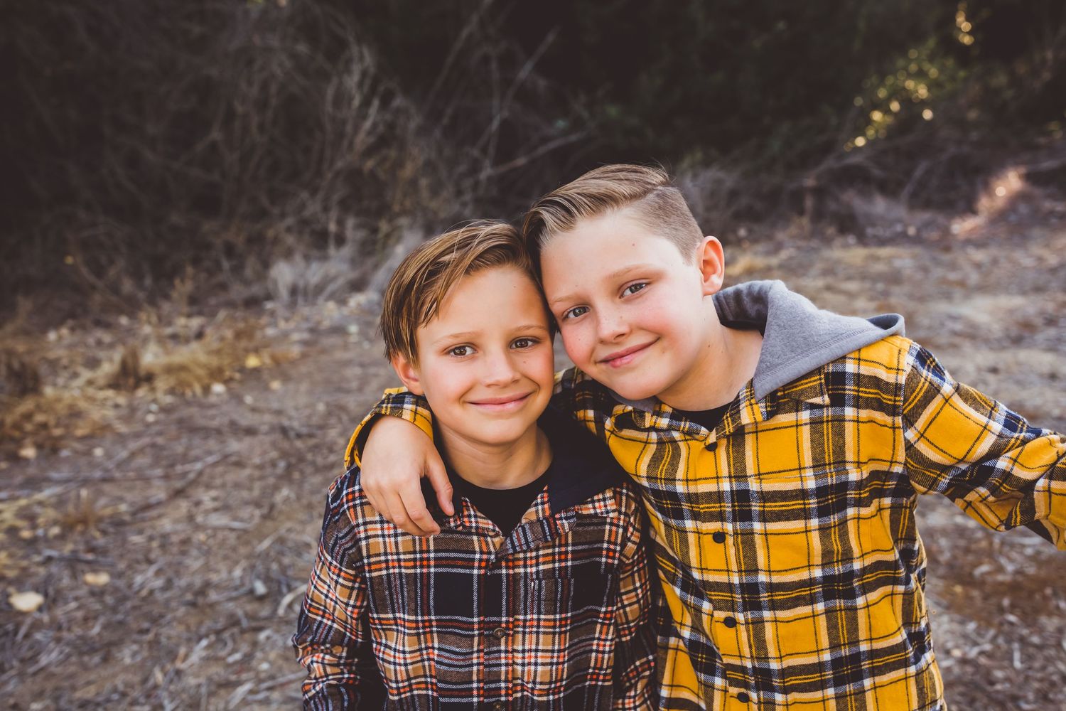 two brothers hug and smile while having their back to school photos taken in beaumont ca