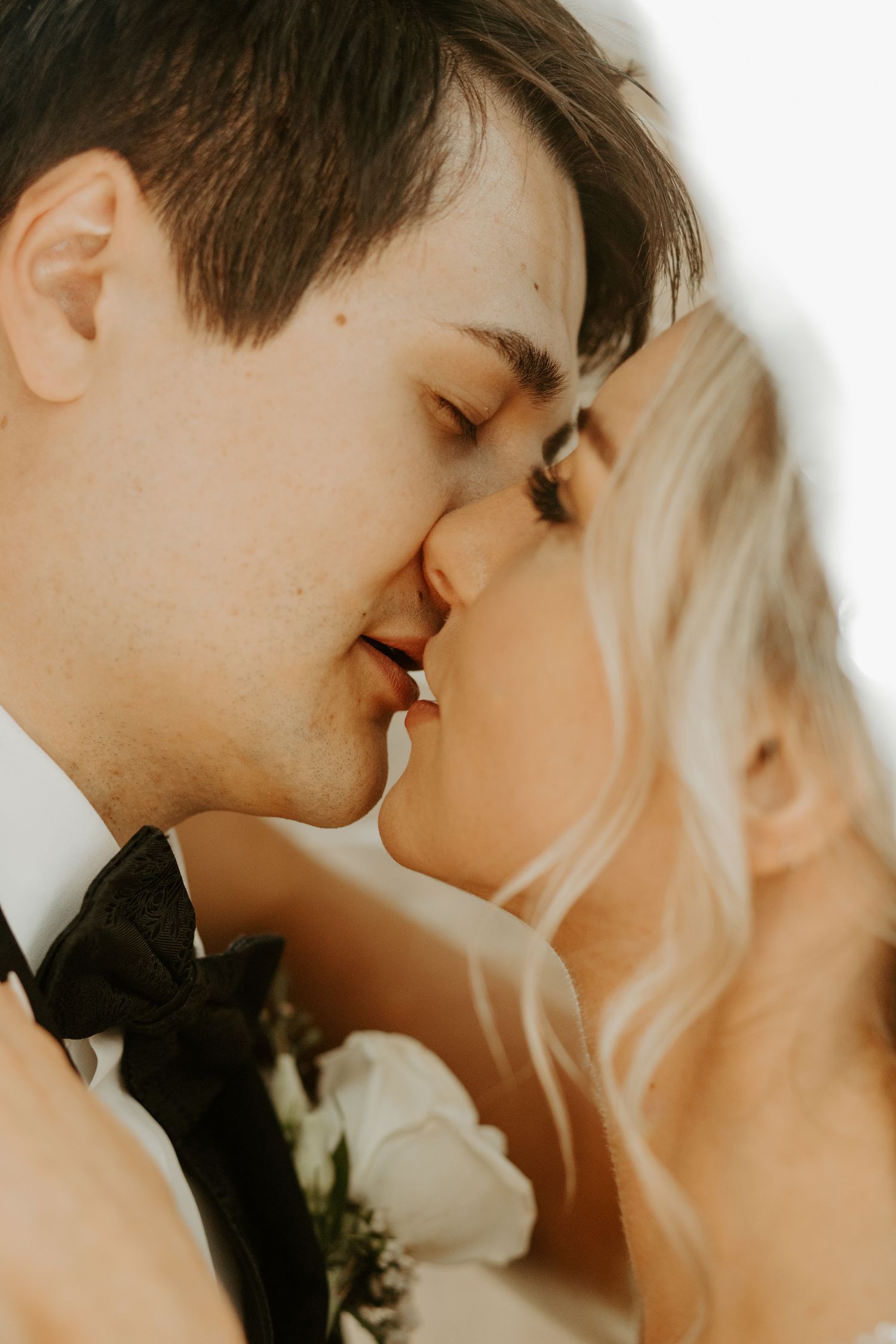 Intimate close-up wedding portrait in soft natural lighting.