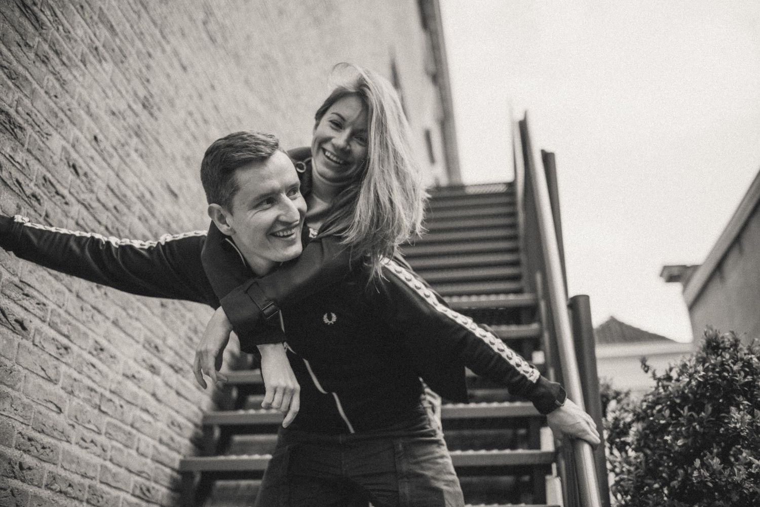 Black and white candid photo of a couple in love. Genuine emotions, captured in the moment.