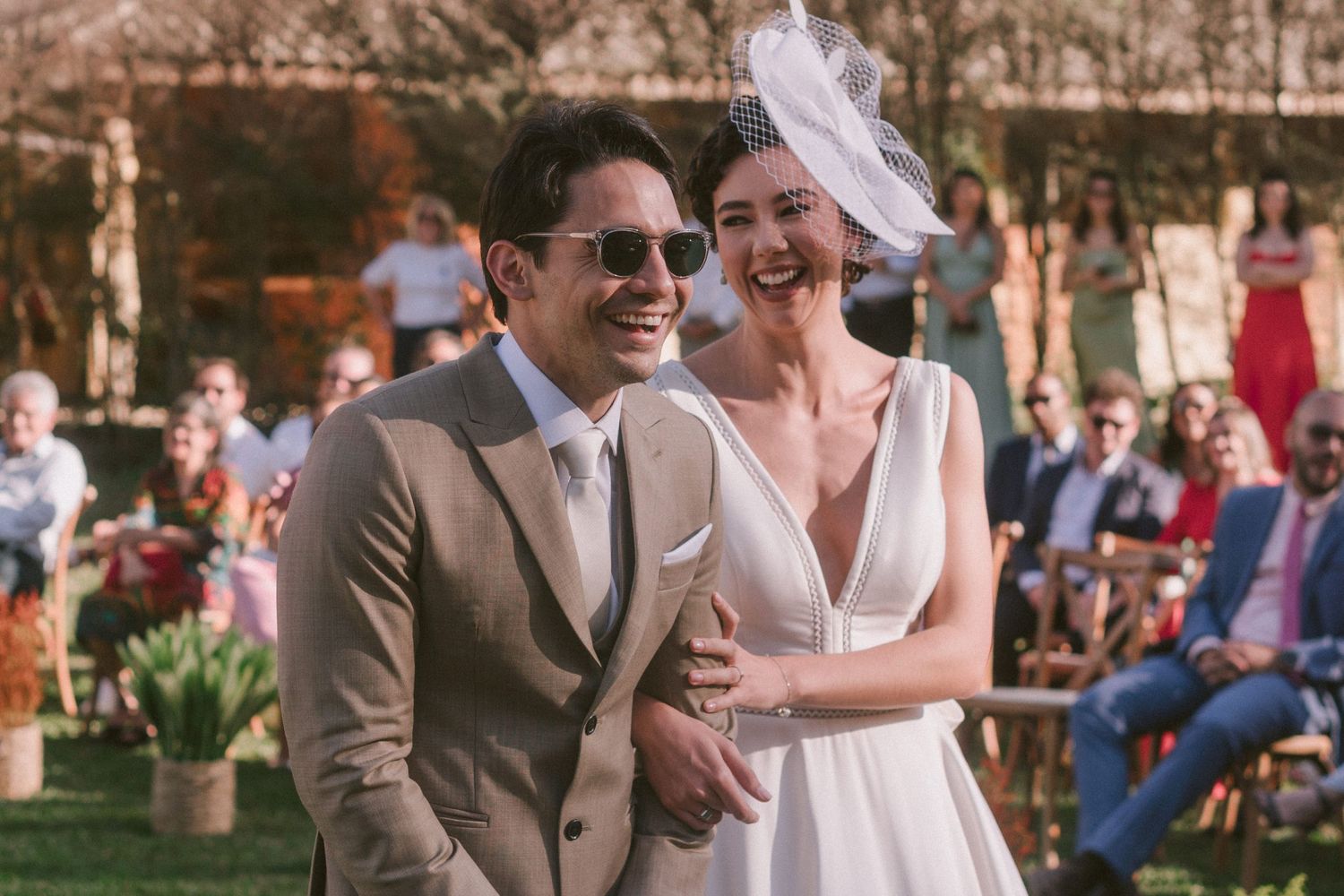 Happy couple sharing a candid moment during their outdoor garden wedding celebration.