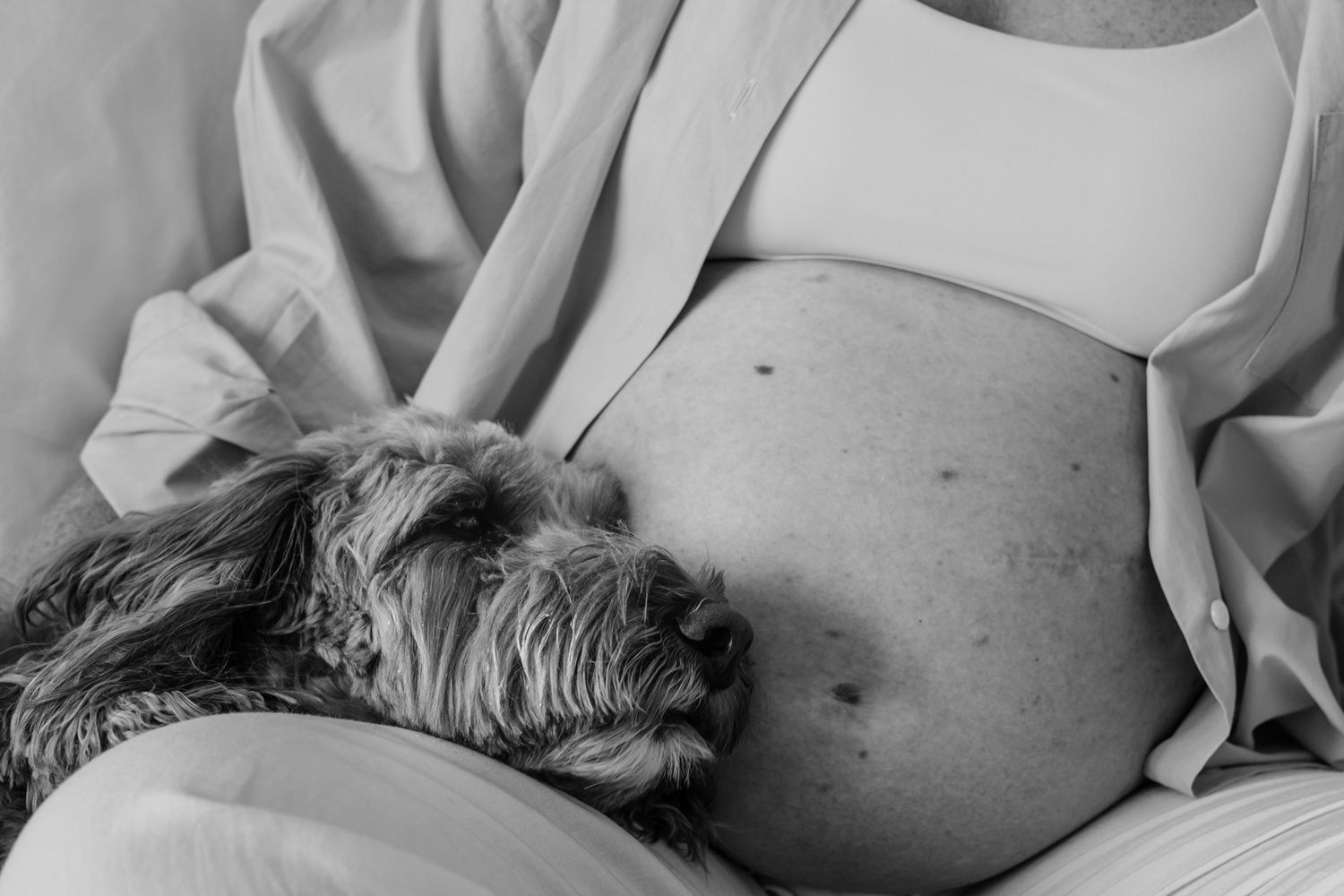 Black and white maternity photography series showing pregnant belly.
