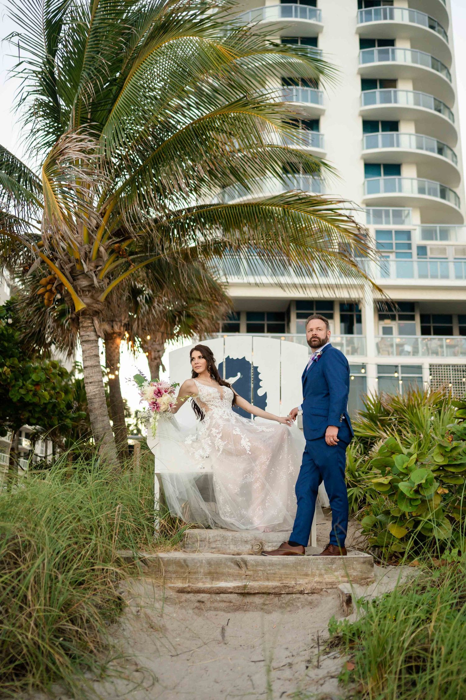 A dramatic wedding photo on illuminated stairs with modern architectural elements.