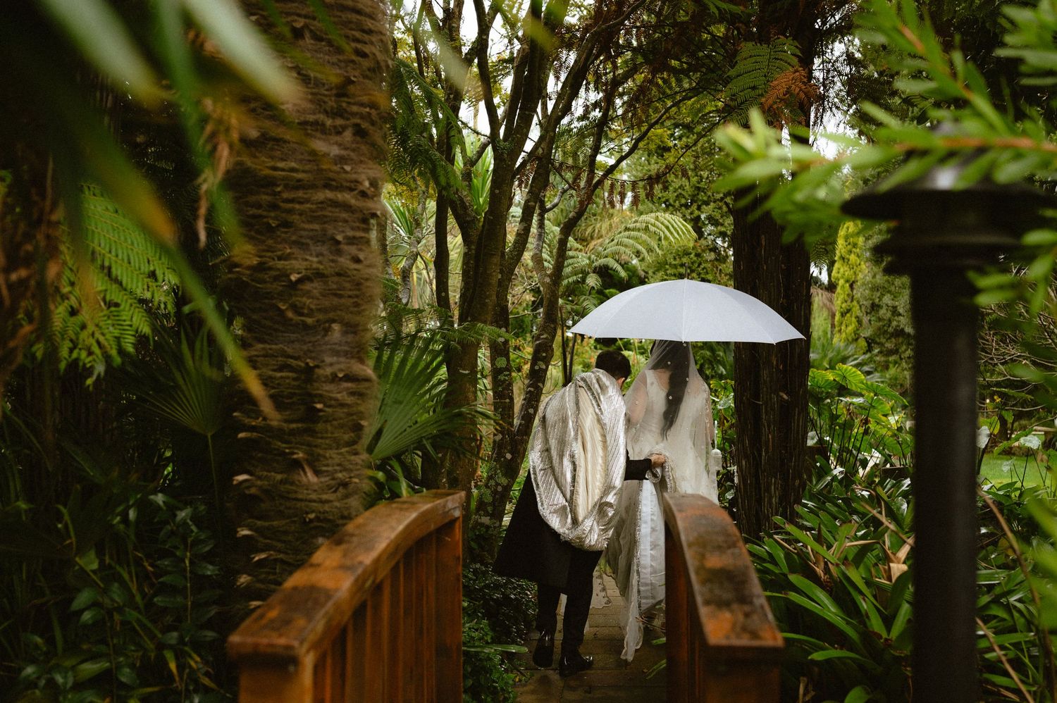 Delicate white veil flows in the breeze during an outdoor wedding ceremony.