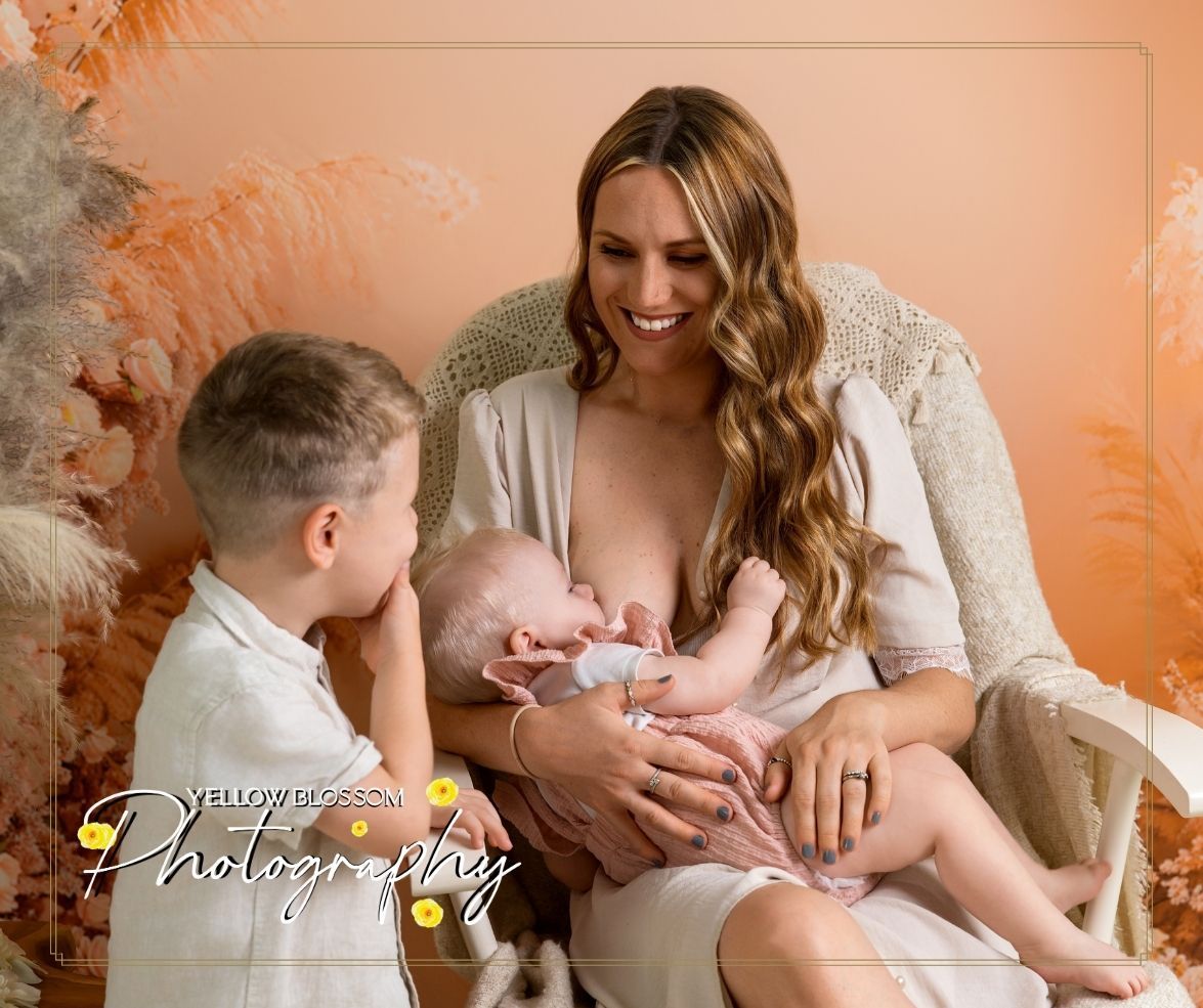 A newborn photography session shows tender family moments captured in warm peachy tones against a neutral backdrop. Haverhill, Suffolk