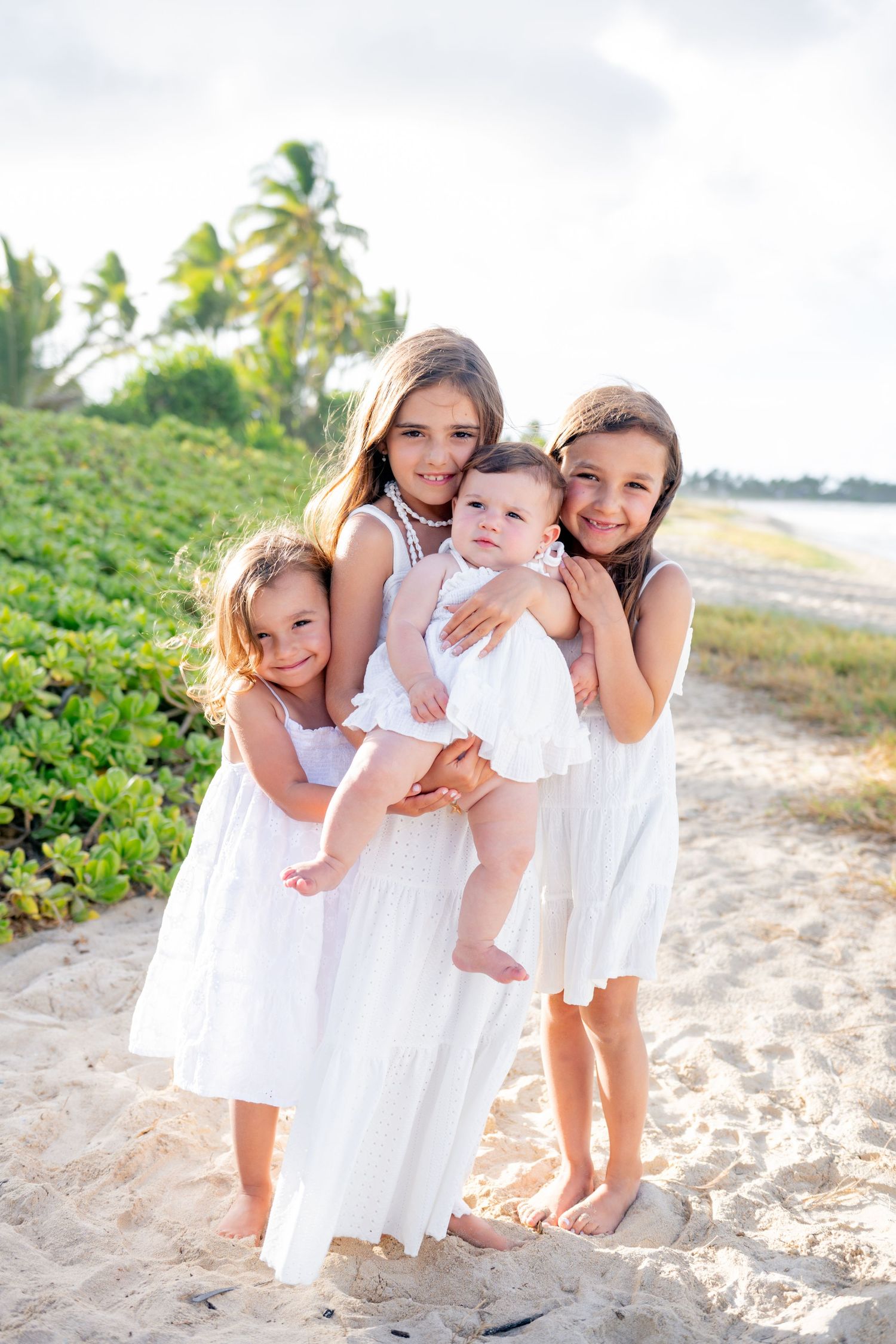 Three sisters and a baby captured during a family photography session on Oahu
