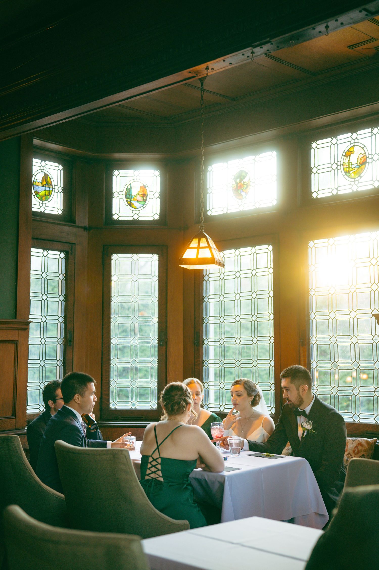 The Mansions on Fifth in pittsburgh pa wedding guests sit inside after ceremony enjoying reception in a classic venue.