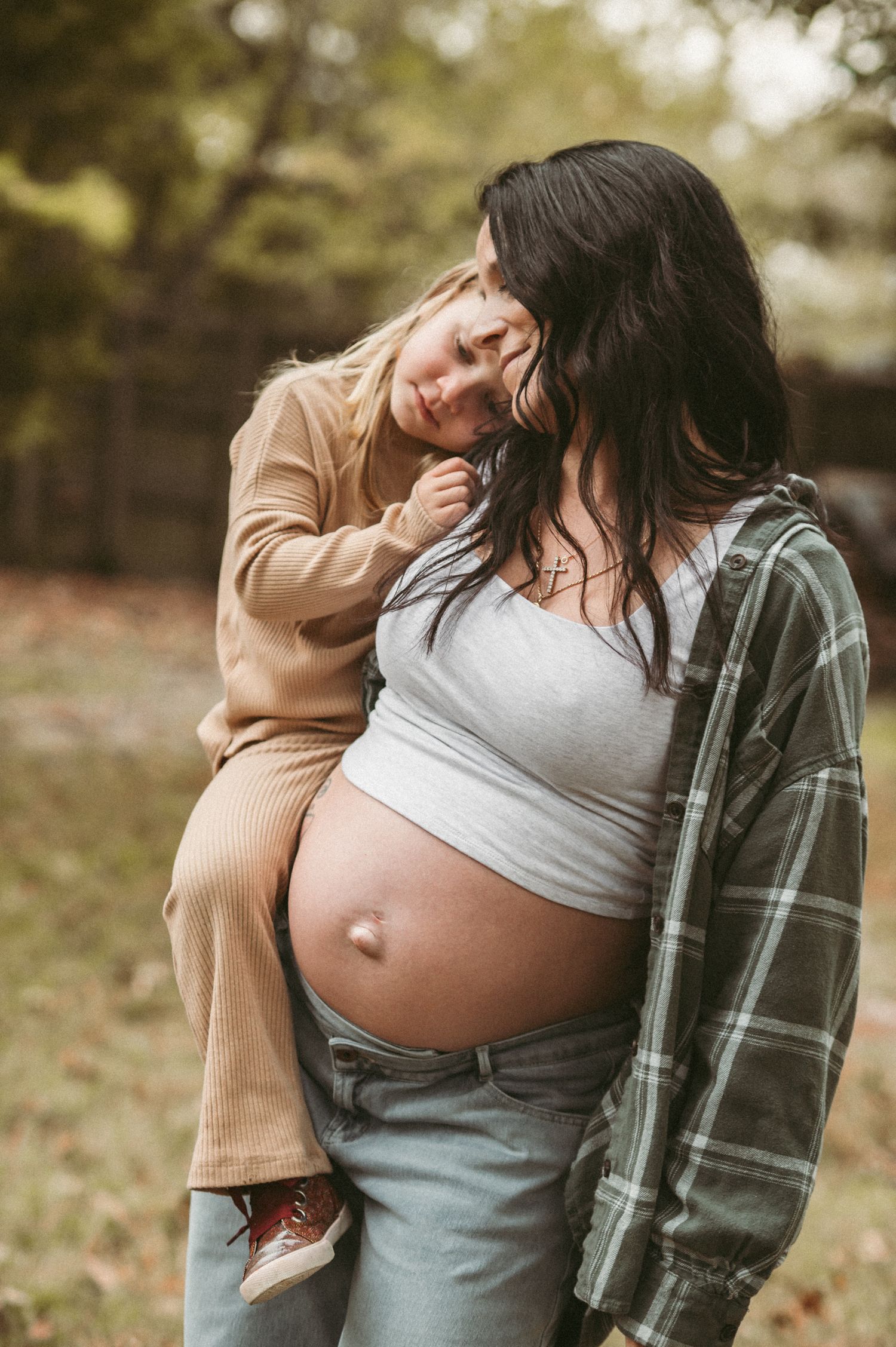Expecting mom's exposed belly taken in her backyard during a maternity session in Chesapeake, Virginia.
