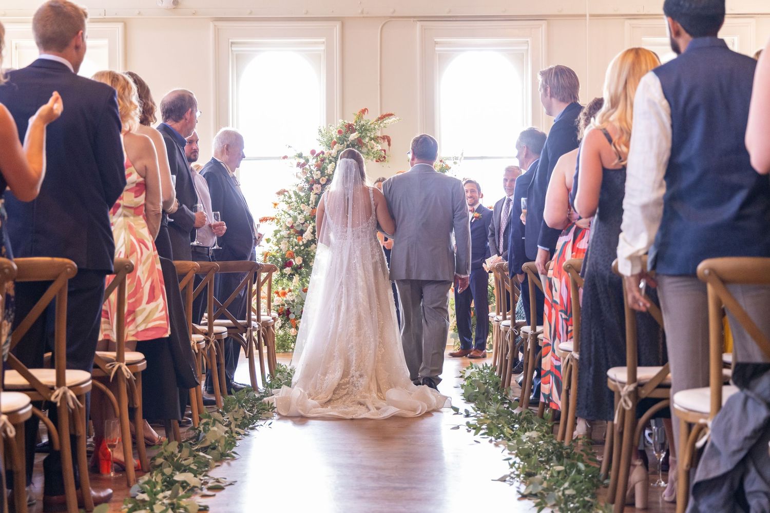 Bride walking down the aisle with escort at the Alcove Cincinnati wedding event space.