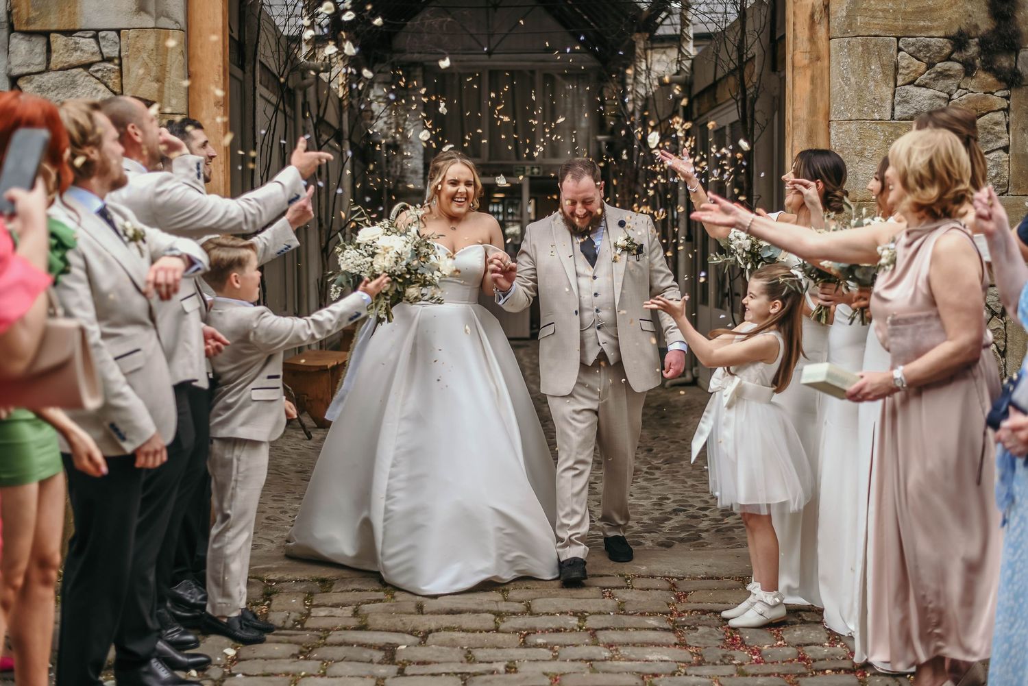 Bride and groom walk through confetti shot at Wyresdale park wedding venue