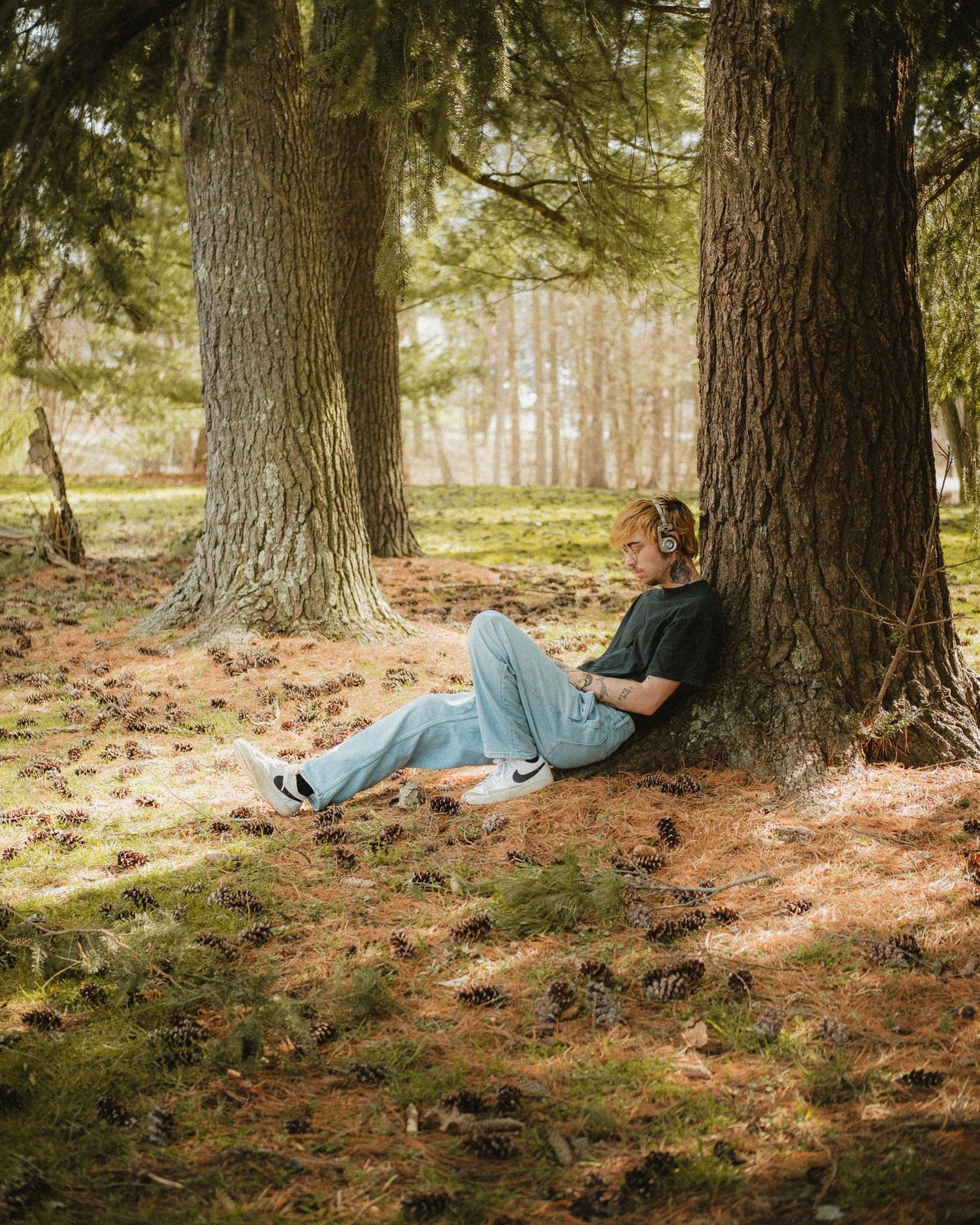 a self portrait sitting under a tree in the Historic Huguenot Street park of New Paltz New York